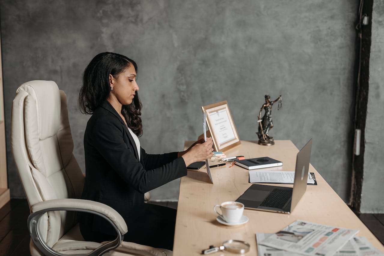 Female law expert sorting documents at desk