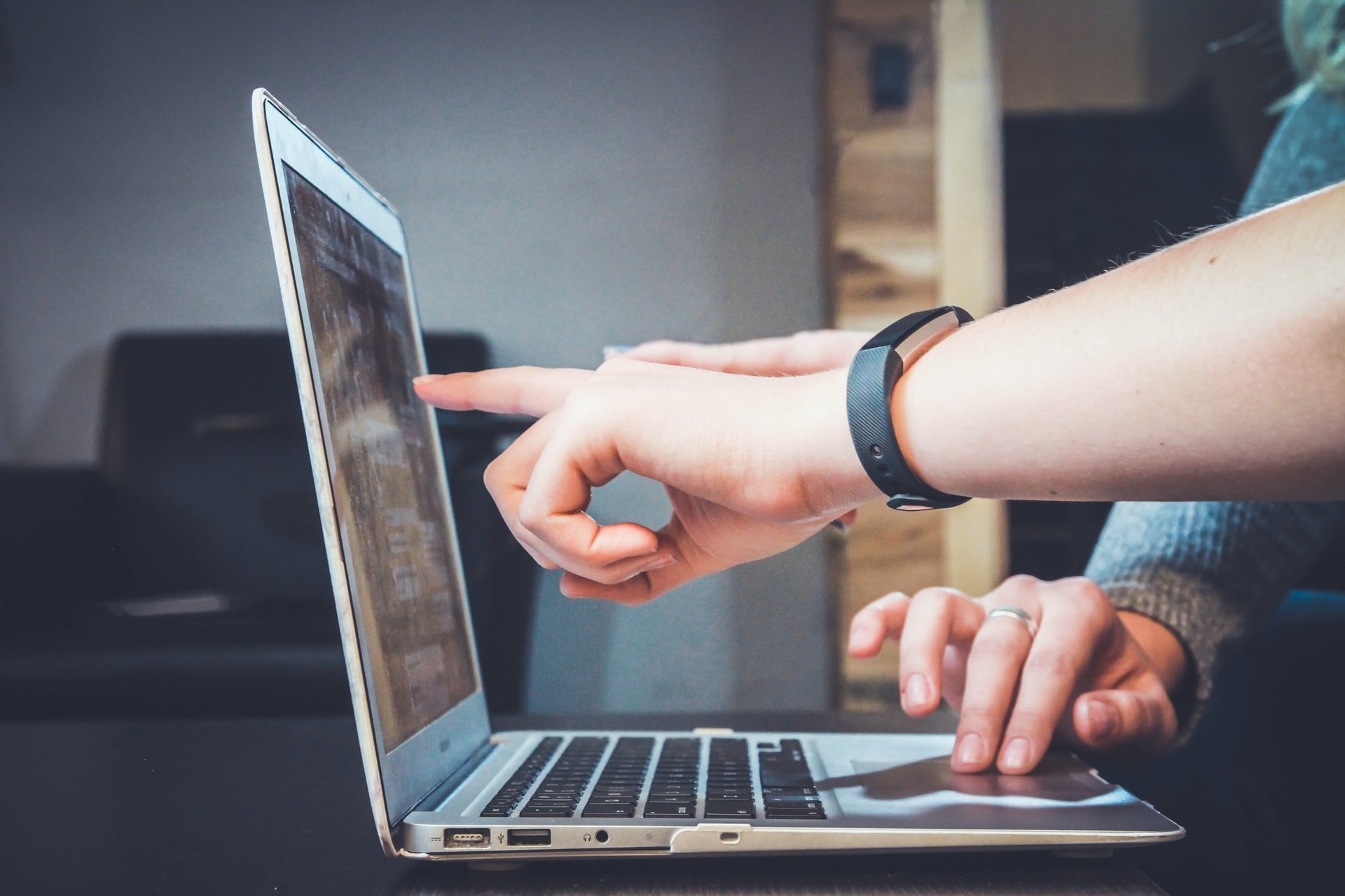 Two people pointing at a laptop screen [Photo by John Schnobrich on Unsplash]